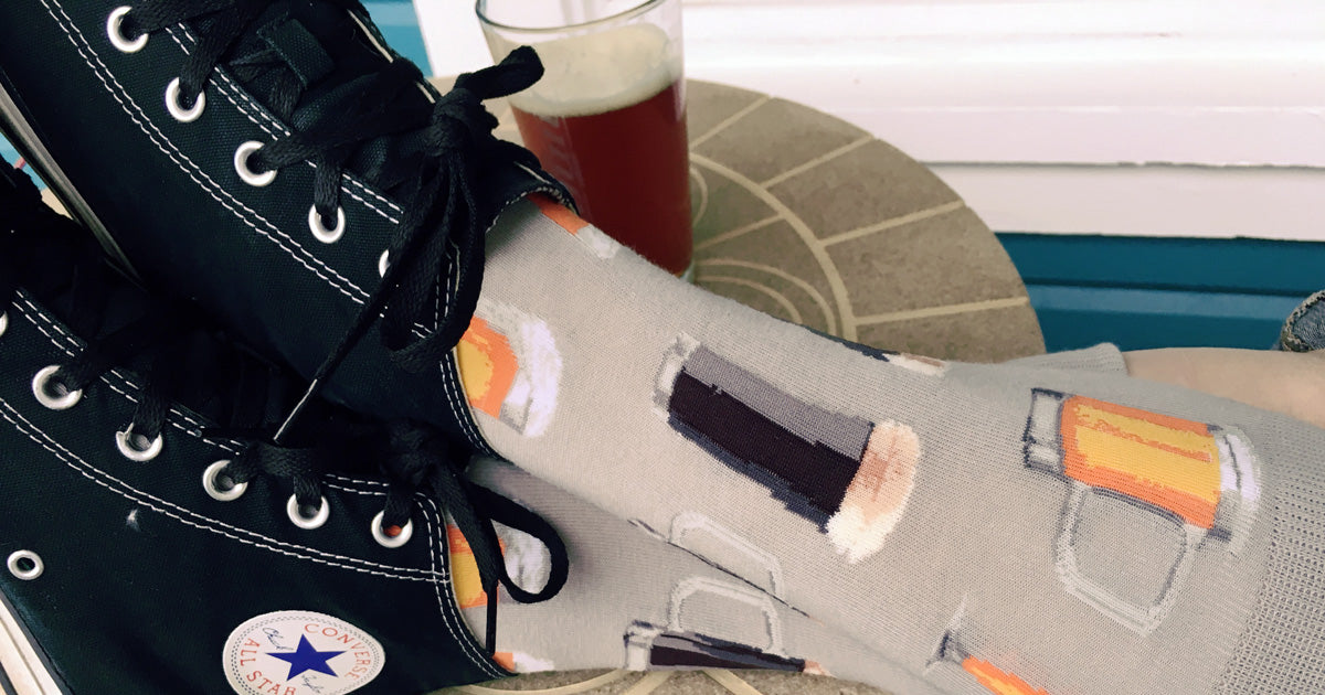 Beer socks with a pattern of craft beer varieties in mugs and glasses.