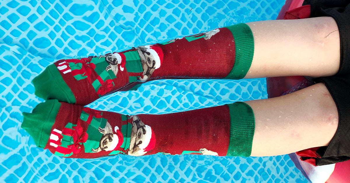Sloth Christmas socks for Christmas in July, worn in the pool!