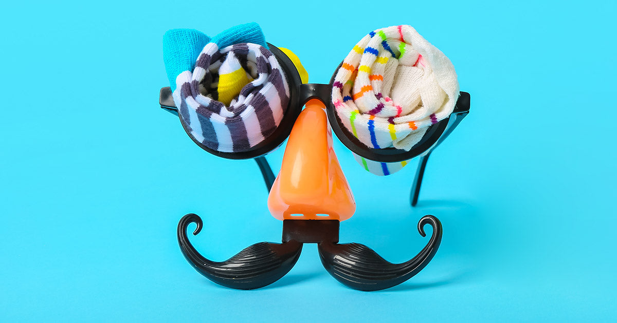 Funny glasses with a fake nose and mustache with rolled up striped socks in the eyes of the glasses.