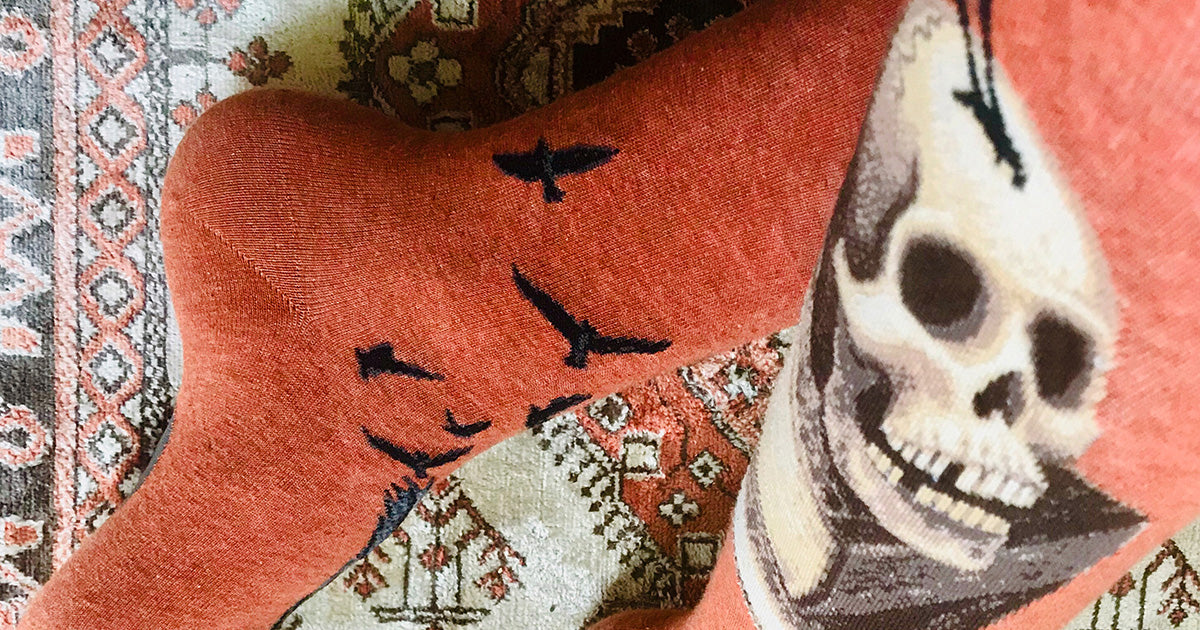 Funny skull socks with ravens represent an Edgar Allan Poe poem, perfect for Halloween.