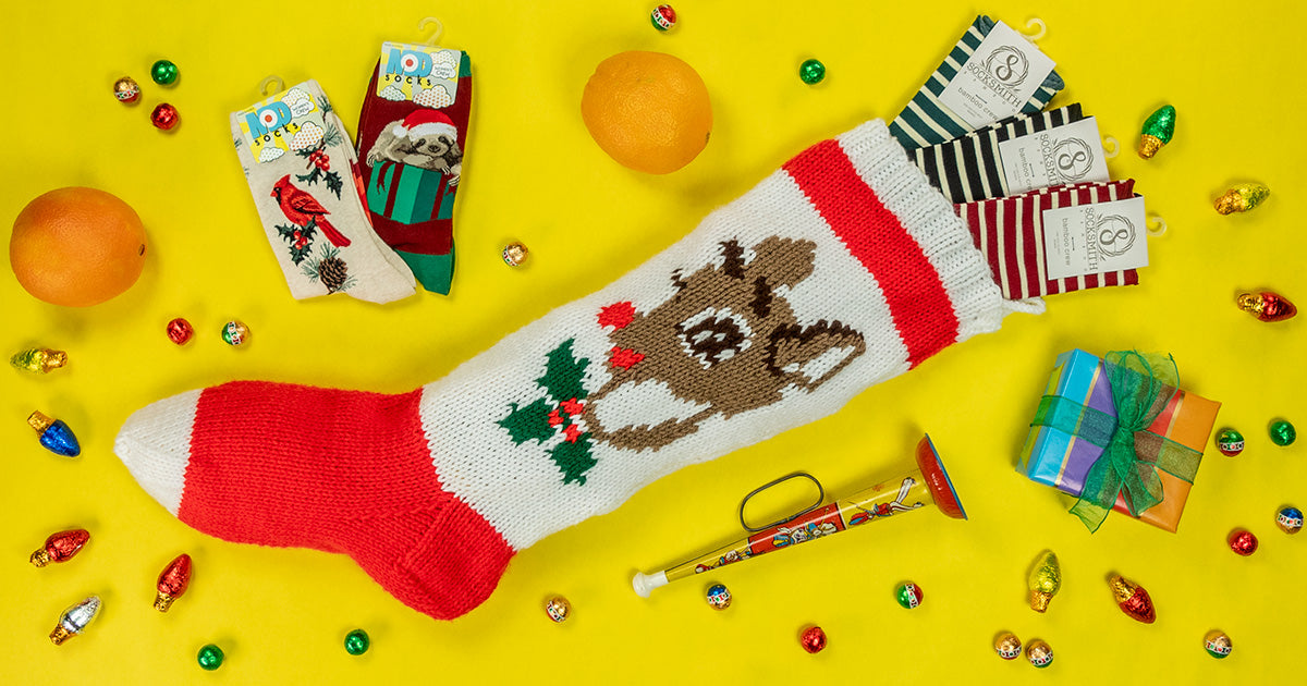 A vintage Rudolph stocking is filled with fun socks, chocolates, oranges and other presents.