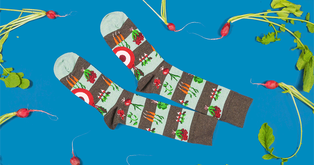 Novelty vegetable garden-themed socks are surrounded by dancing radishes.