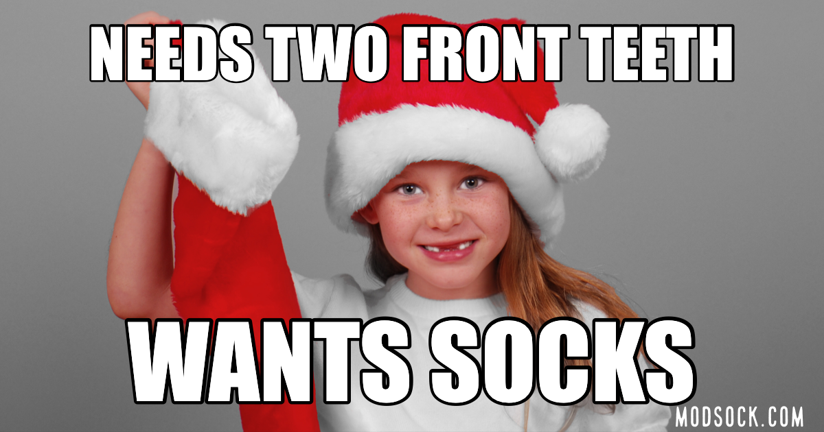 Girl missing two front teeth wants socks Christmas meme that says "Needs two front teeth, wants socks."