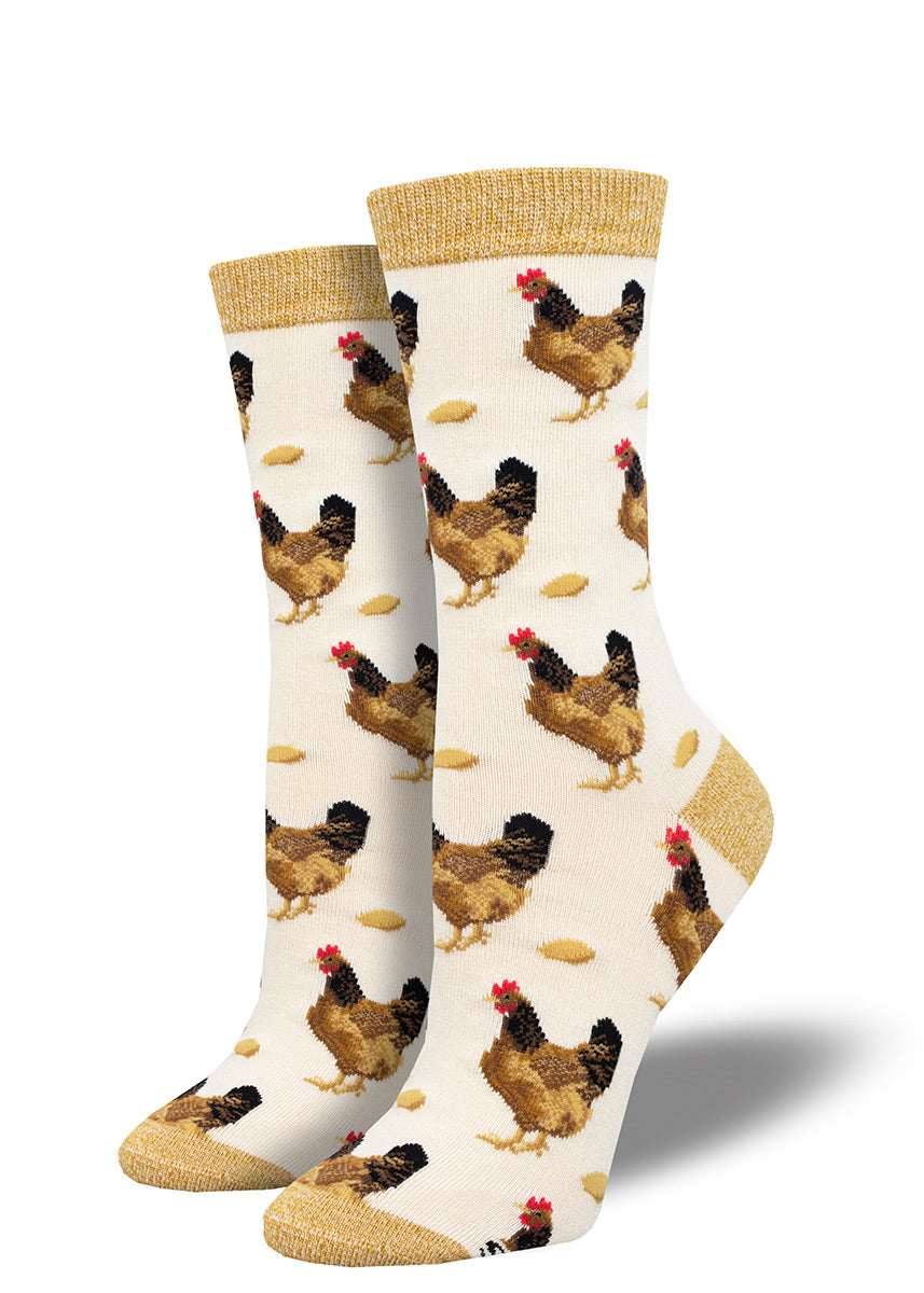 Ivory women's crew socks with an allover pattern of brown hens and chicken eggs, accented in tan at the heel, toe and cuff.