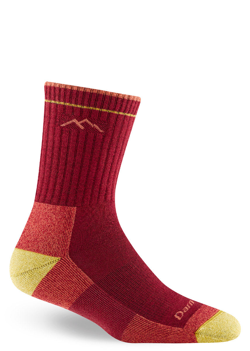Red wool hiking socks for women in crew length, with orange and yellow accents on the foot.