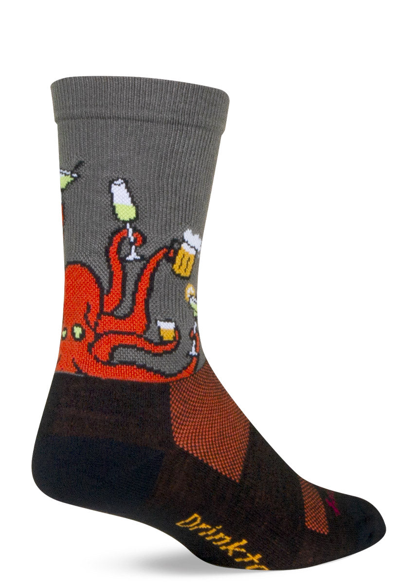 Gray, black, and orange athletic socks feature a design of an orange octopus holding a different alcoholic beverage in each of its eight tentacles and have &quot;Drinktopus&quot; written on the bottom of the foot.
