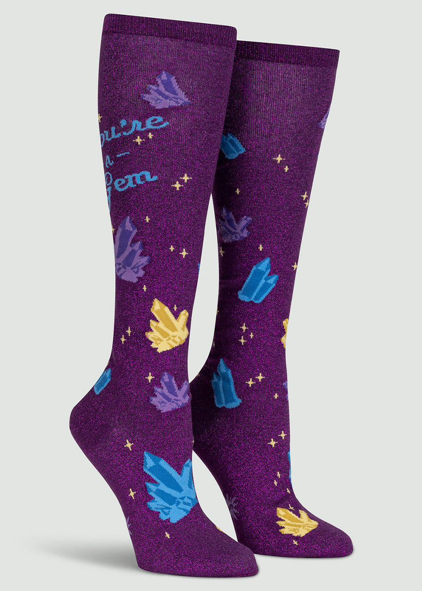 Shimmery metallic purple knee socks with the words “You&#39;re a Gem&quot; surrounded by a pattern of colorful crystals. 