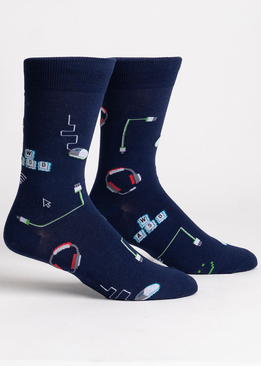 Navy blue crew socks for men that have a computer design, including AWSD keys, the wifi symbol, a mouse icon, headphones, a computer mouse, and a USB cable. 