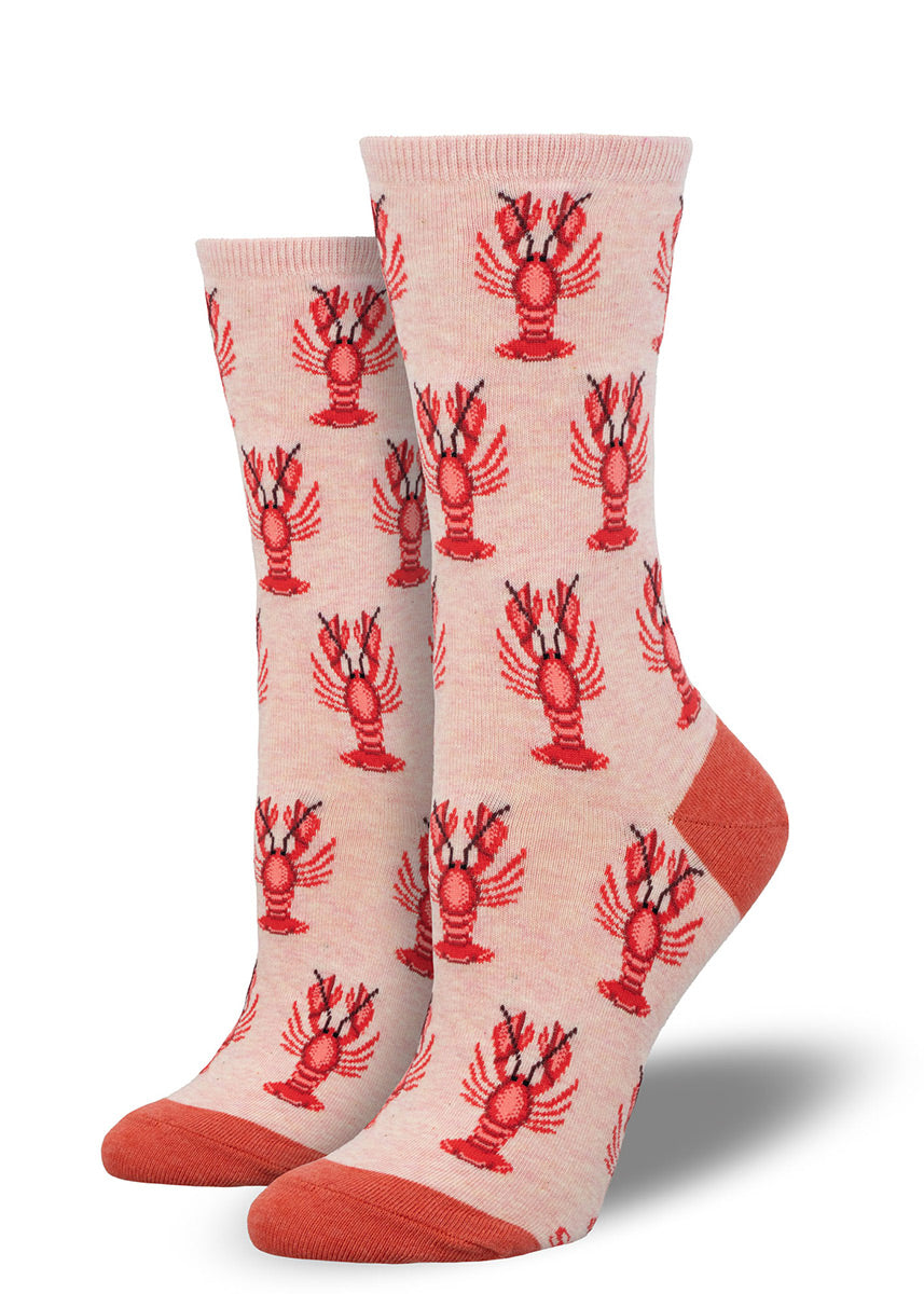 Pink crew socks for women with an allover pattern of red lobsters.