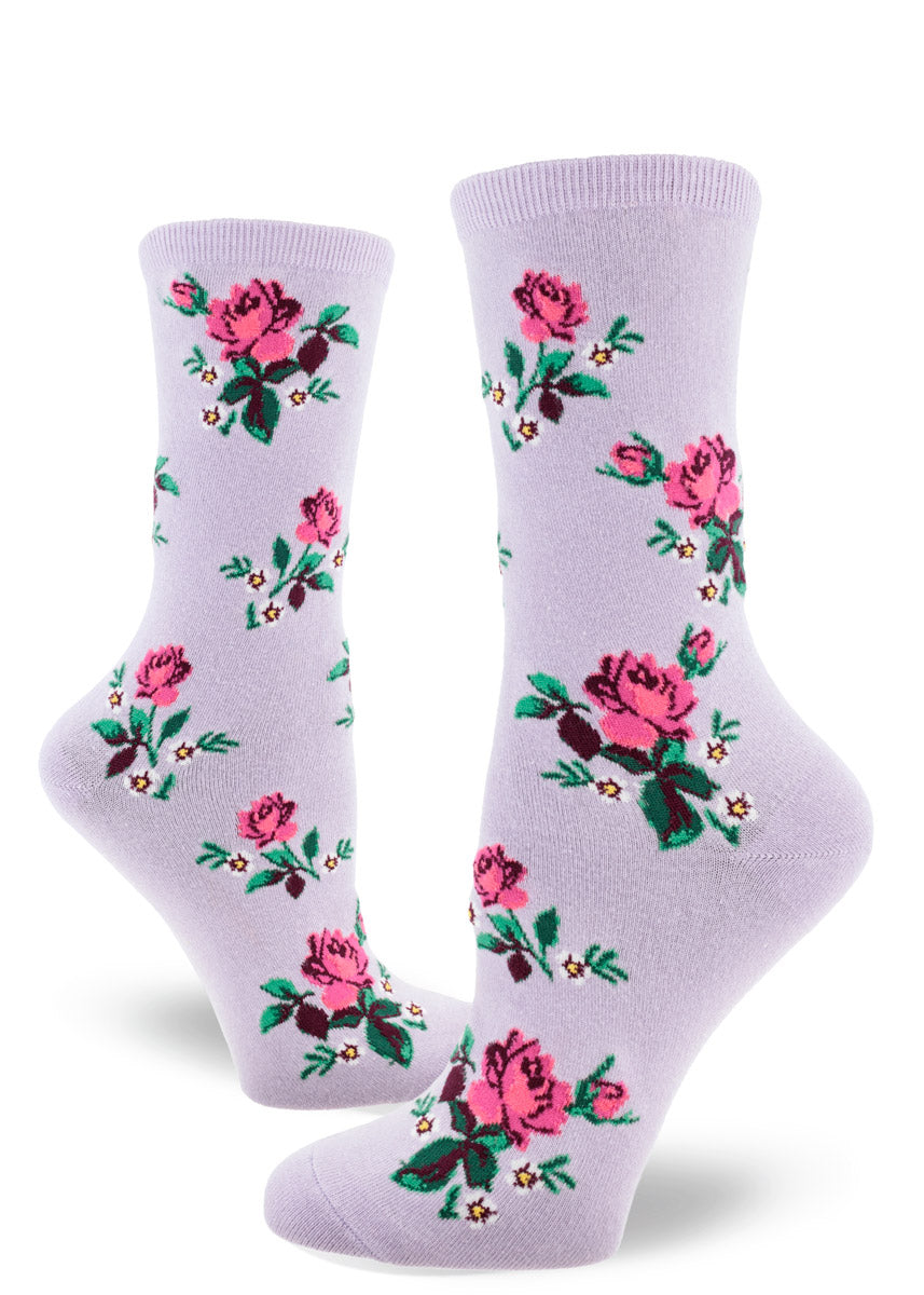 Light purple crew socks for women that have an allover pattern of pink roses and white floral accents.