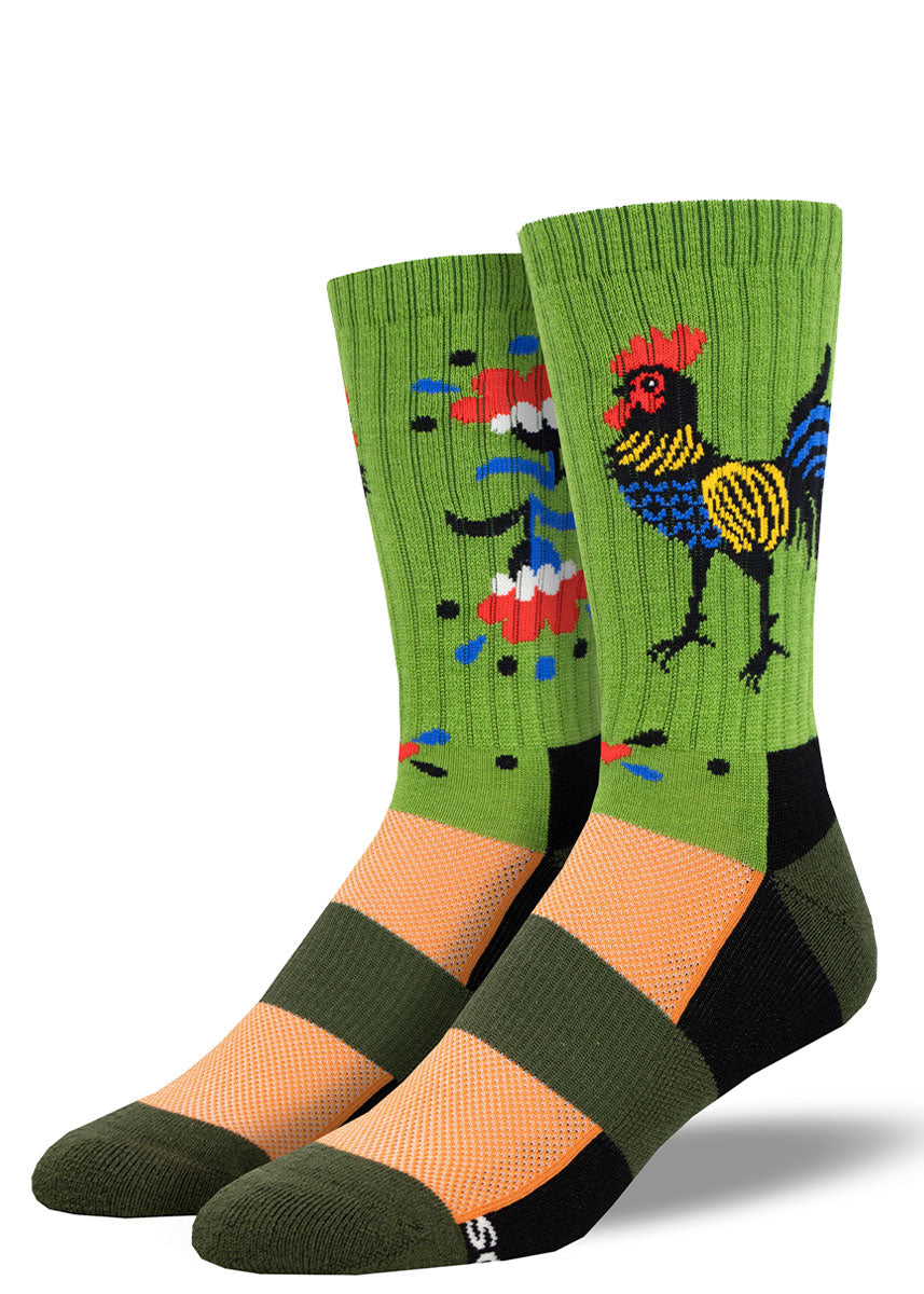 Green, light orange, and dark green striped hiking socks for men that depict a red, yellow, and blue rooster design on one side and a floral design on the other.