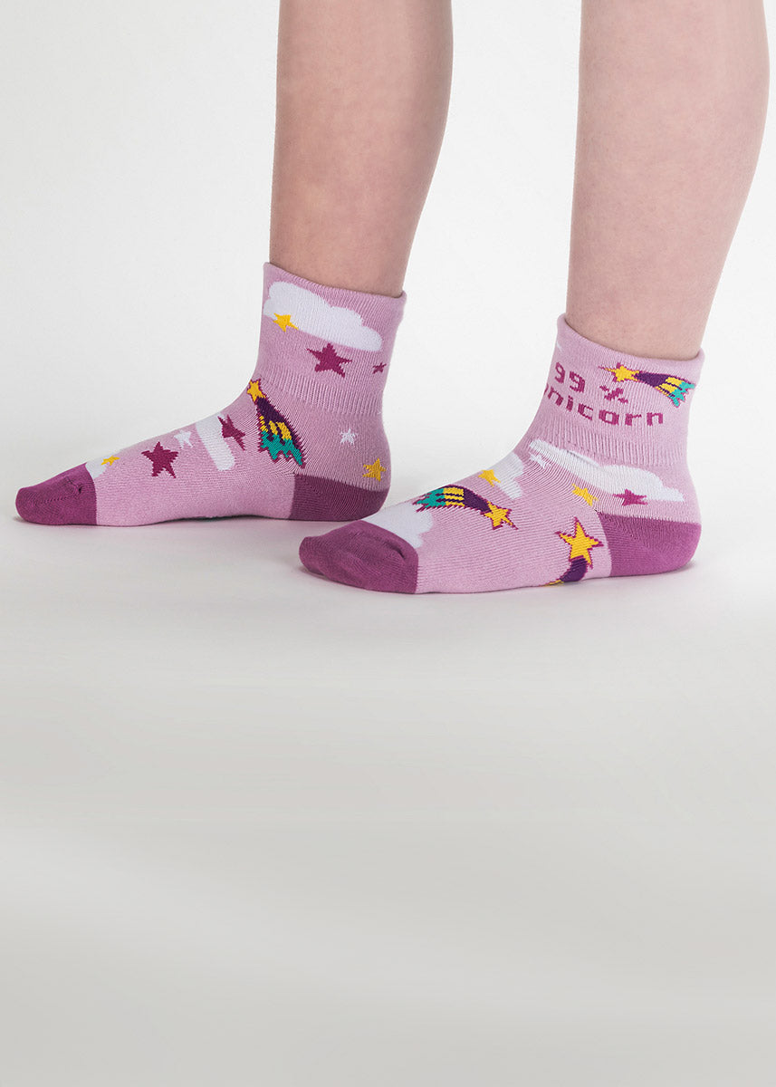 Cuffed kids' socks in light purple-pink with shooting stars, clouds and a unicorn face on the turned-down cuff that flips up to say “99% unicorn.” 