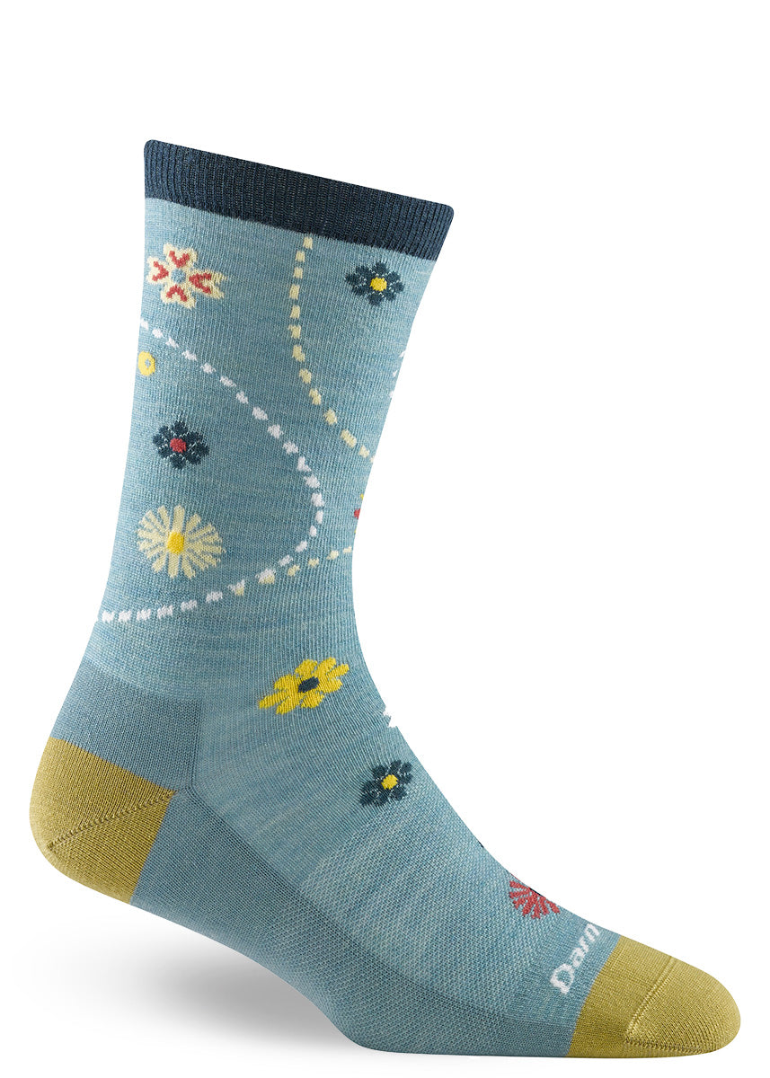 Aqua wool crew socks with bold blue, red and yellow flowers reminiscent of a summer garden.