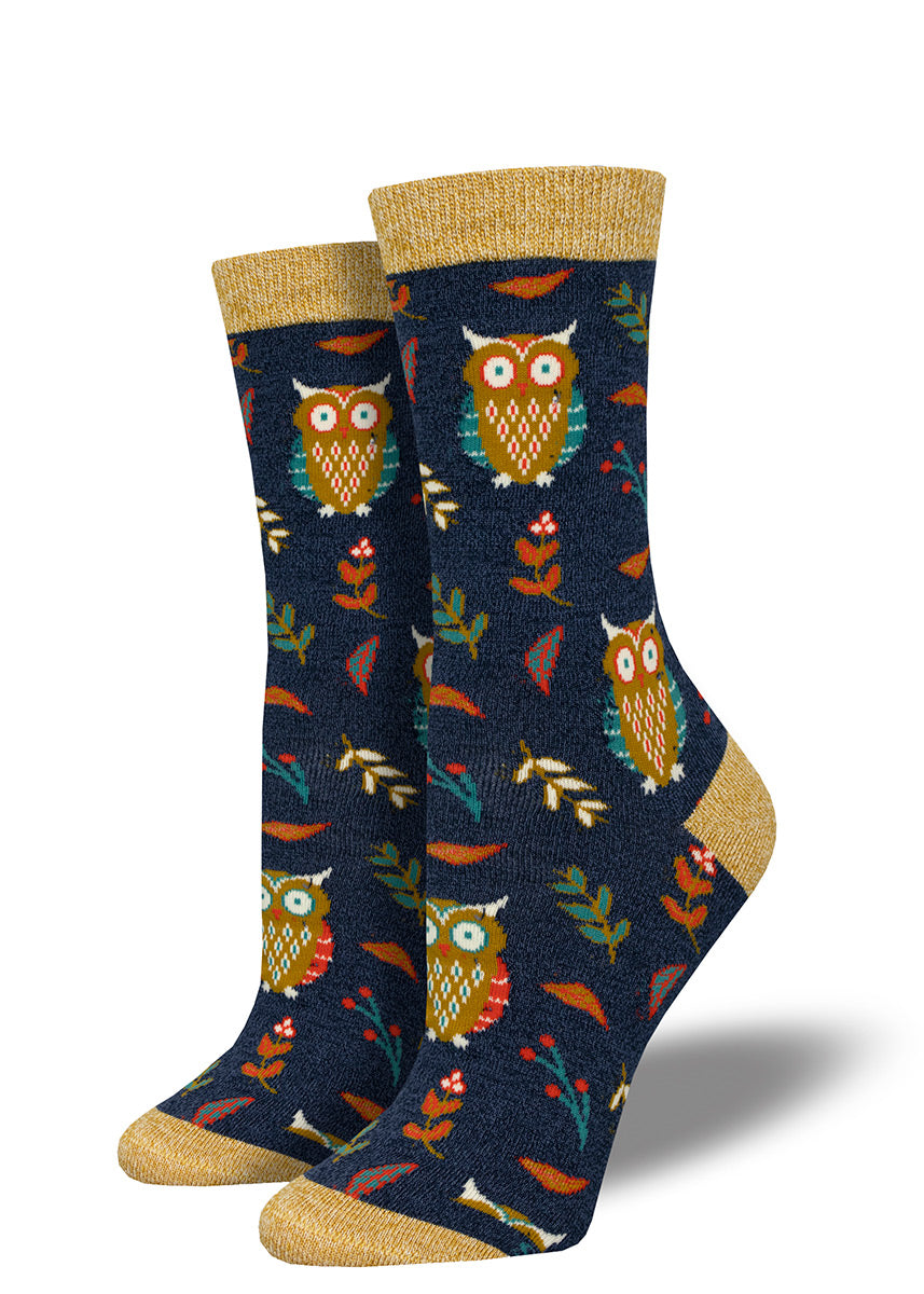 Bamboo owl socks for women with a pattern of retro &#39;70s style owls and fall foliage in golden brown tones on a navy background.