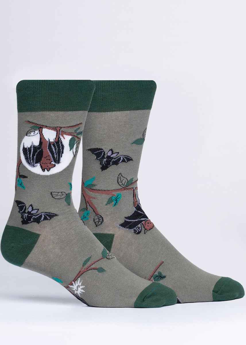 Bat socks for men show adorable bats flying and hanging from branches in front of a full moon that glows in the dark!