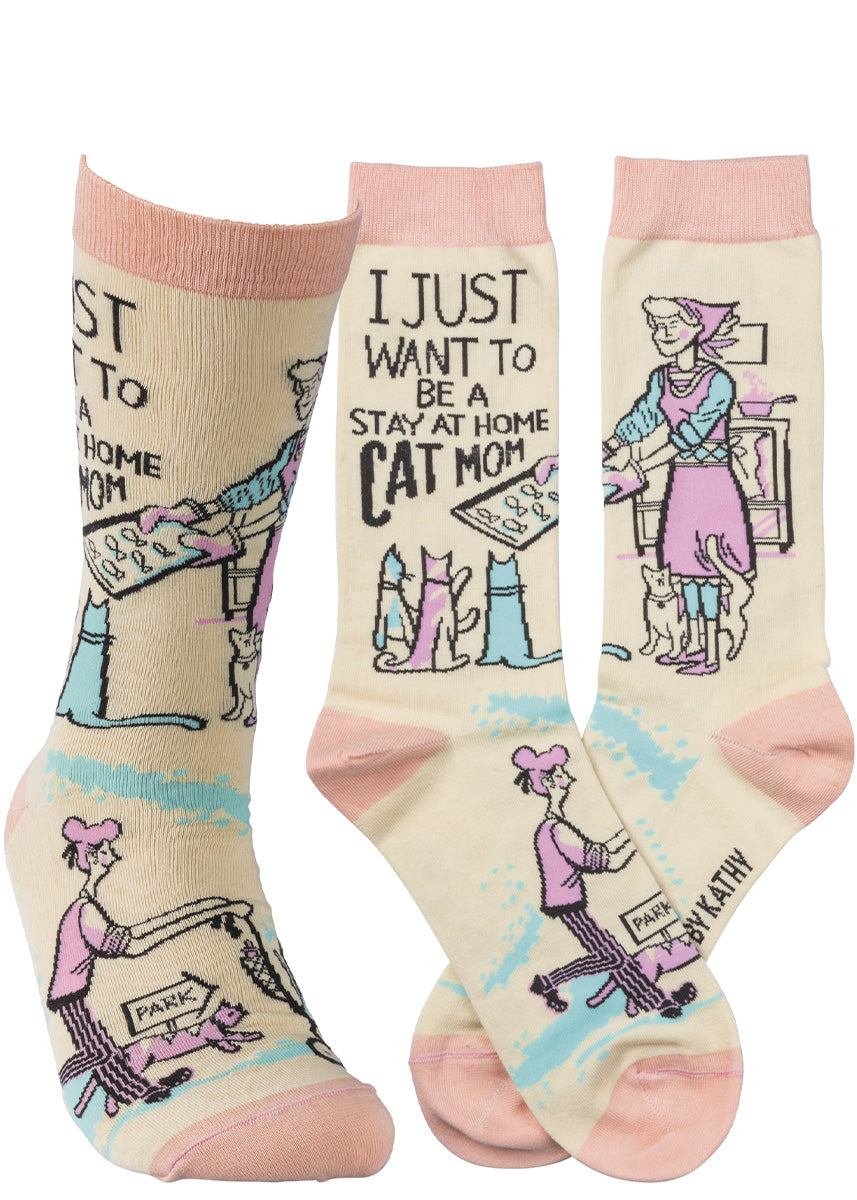 Funny cat socks for women show a cat-owner baking treats for her cats and taking them on walks with the words, "I just want to be a stay-at-home cat mom!"