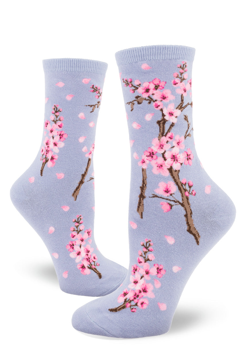 Floral crew socks for women feature bright pink cherry blossoms on a pale lavender background.