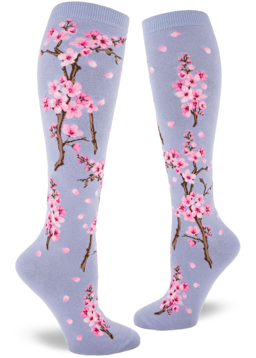 Knee socks for women feature pale pink cherry blossoms on a mint green background.