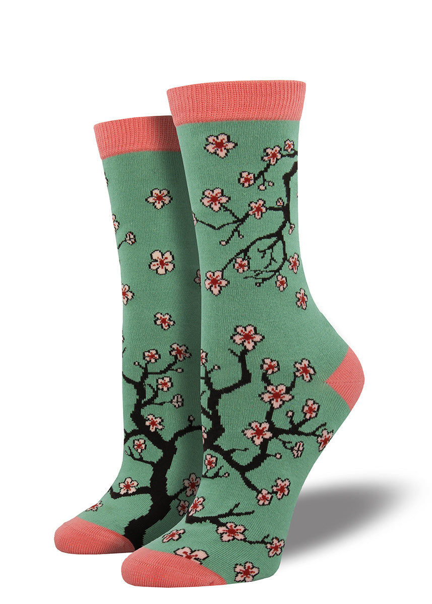 Cherry blossom bamboo socks for women with springtime flowers on a teal background