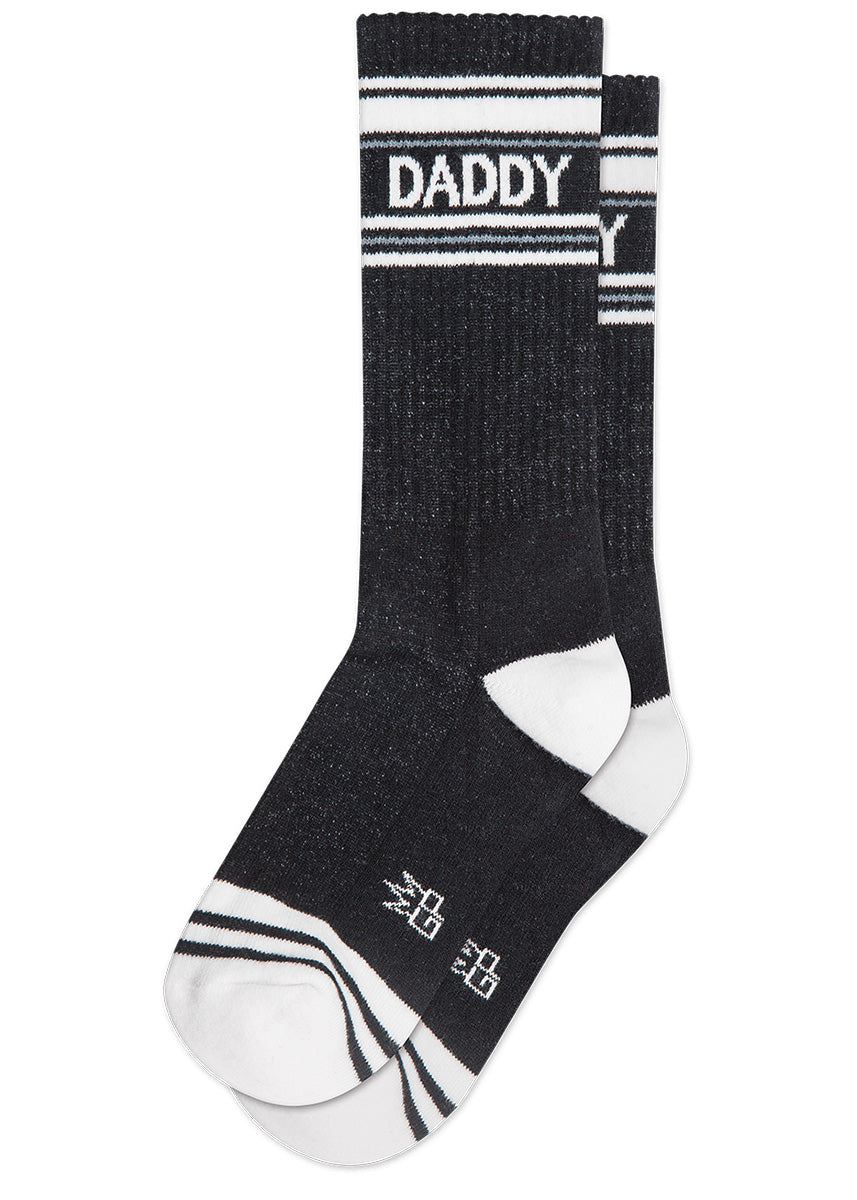 Funny unisex socks say &quot;DADDY&quot; on a retro-inspired black background with white stripes and accents.