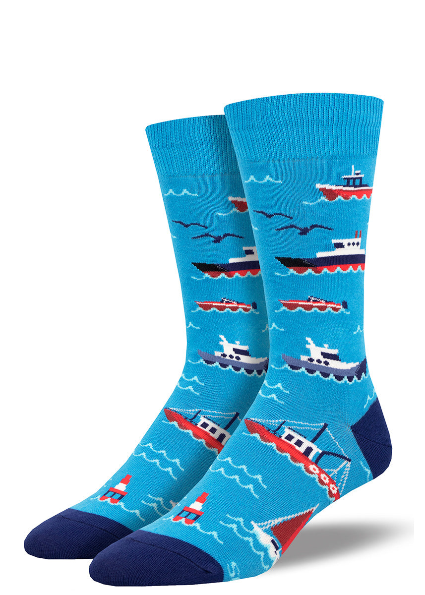 Blue men's crew socks with a nautical motif featuring blue and red boats, ships, ferries and other sea vessels .