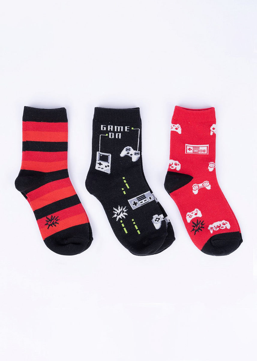 Three pairs of coordinating red and black socks for kids in a video game theme.