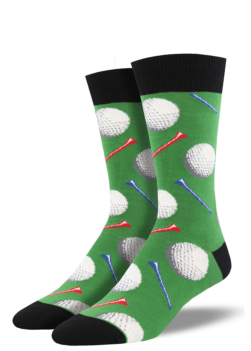 Golf socks for men with golf balls and golf tees, with a green background.