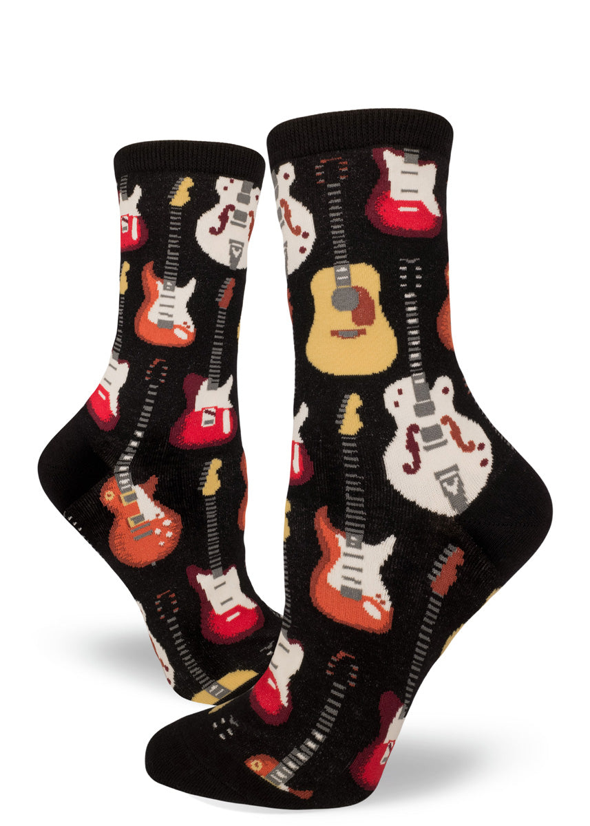 Women&#39;s socks with guitars on a black background.