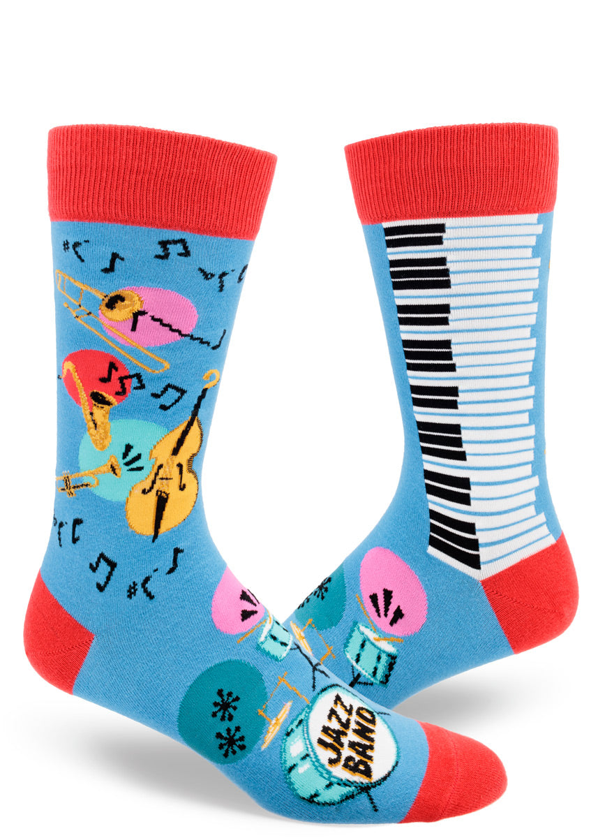 Blue men's crew socks with red accents feature a colorful jazz band design that includes saxophones, trumpets, trombones, standup bass, piano keys and drum sets, plus lots of music notes.