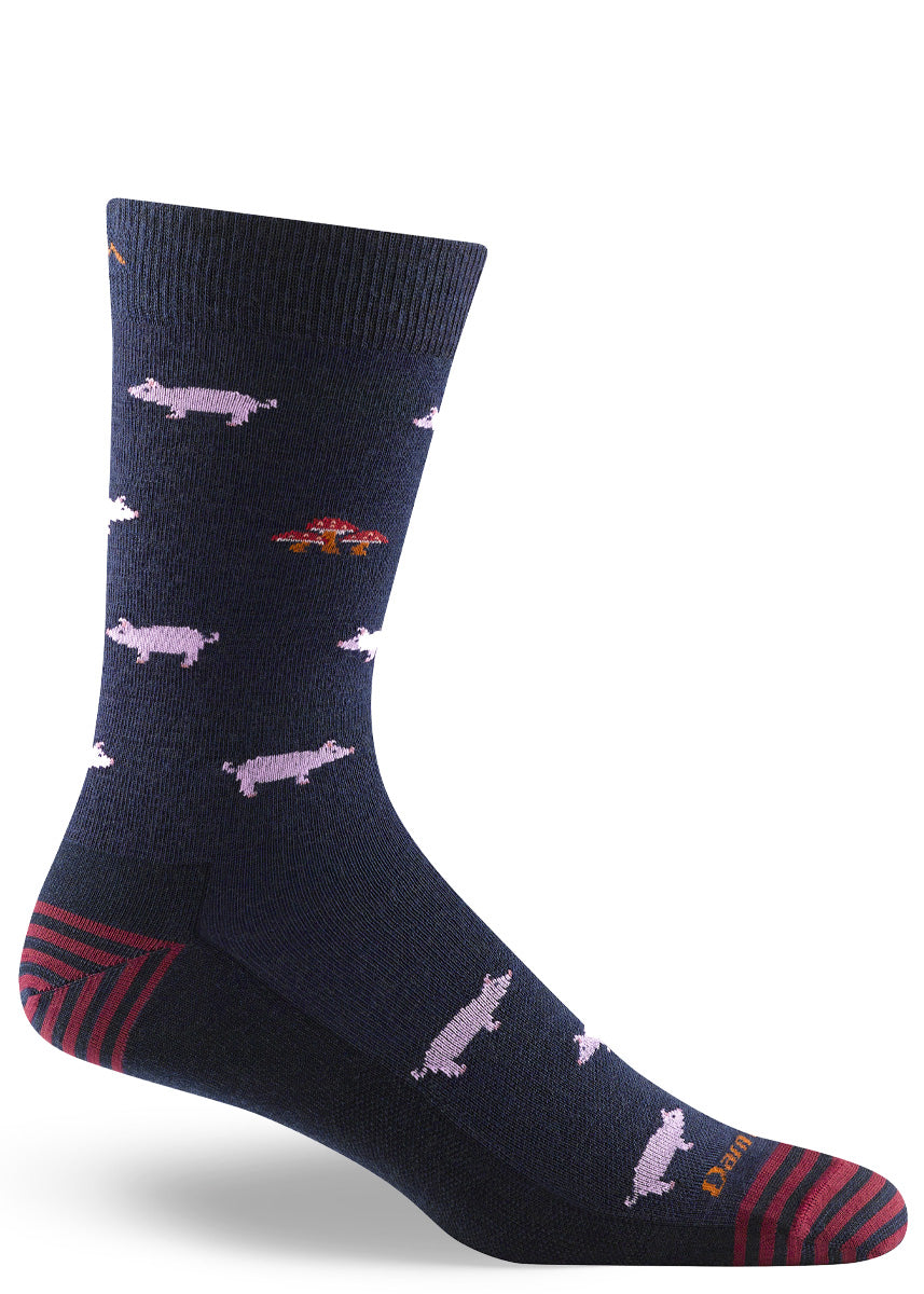 Merino wool dress socks for men in navy with a pattern of small pink pigs and red mushrooms.