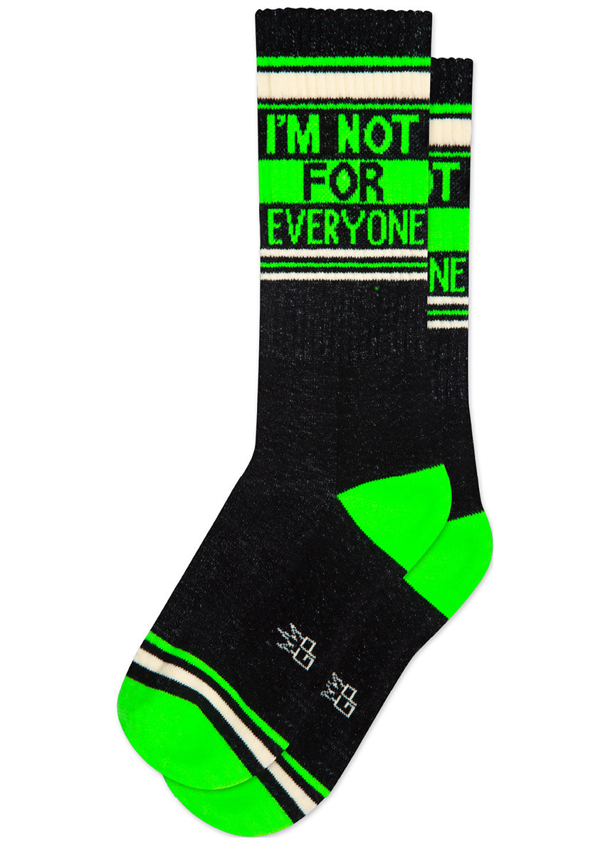 Black retro gym socks with bright green and white stripes and the phrase “I&#39;M NOT FOR EVERYONE&quot; on the leg.