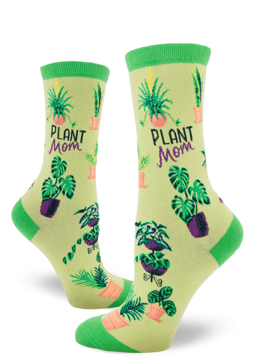 Green crew socks featuring an assortment of potted plants and the words “Plant Mom.”