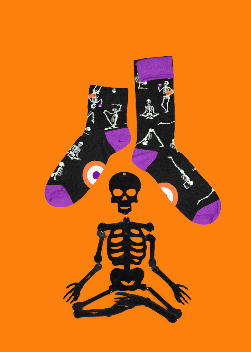 Funny Halloween socks for men feature skeletons in different yoga positions.