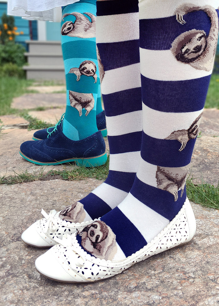 Cute animal knee socks show sloths hanging from teal or navy stripes.