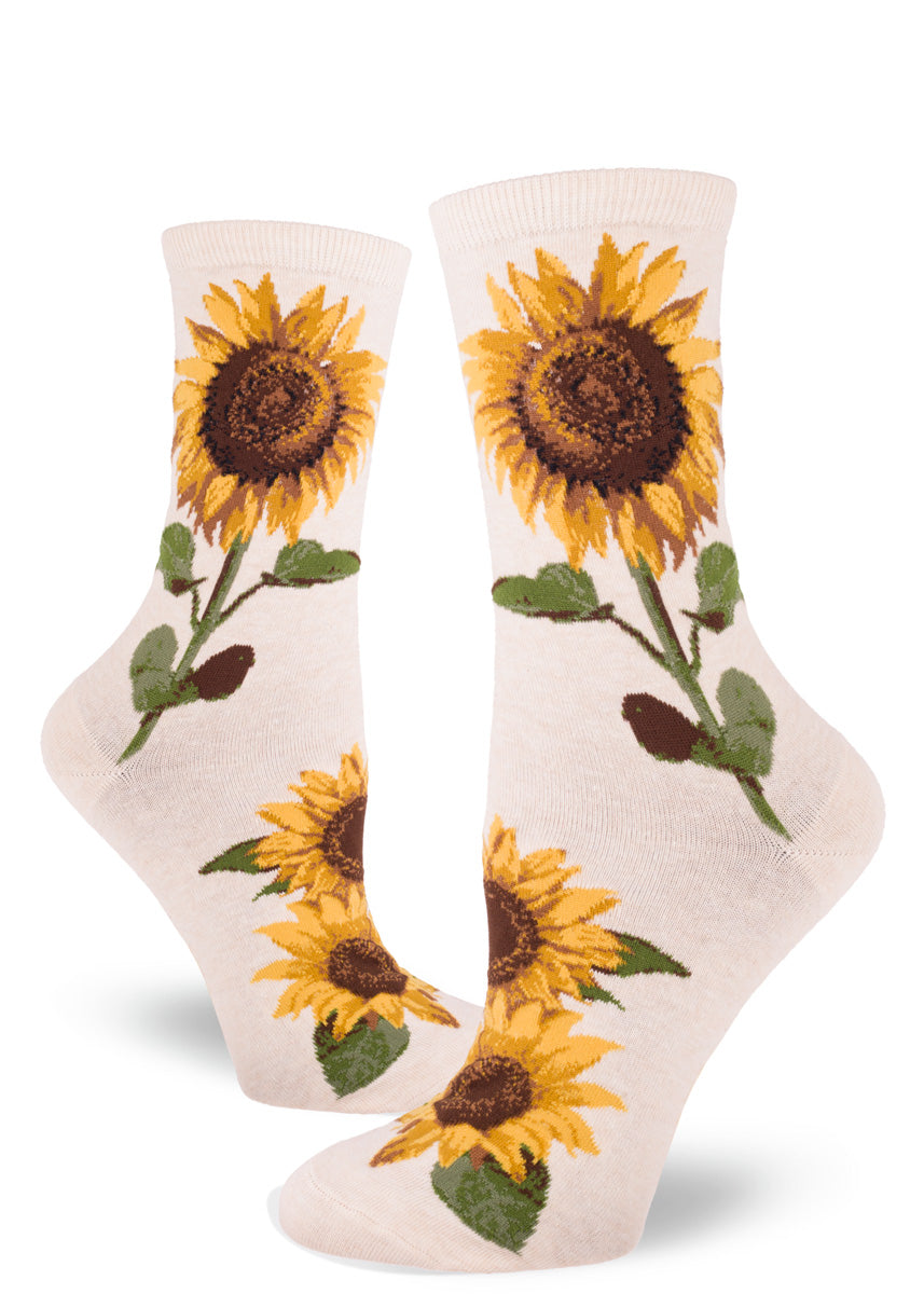 Crew socks for women feature golden summer sunflowers on a cornflower blue background.