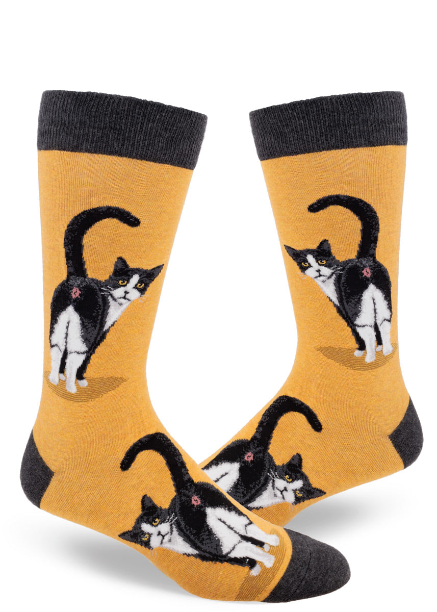 Gold men's crew socks with a design of tuxedo cats inviting you to peek at their butts.