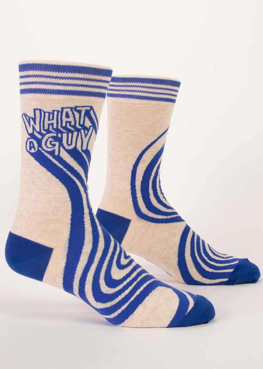 Ivory heather men&#39;s crew socks with blue accents say “WHAT A GUY” on the leg.