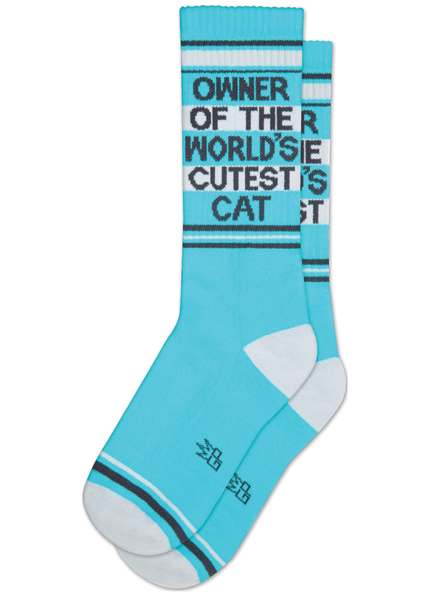 Funny blue crew-length dog socks that say “OWNER OF THE WORLD'S CUTEST CAT” on the leg.