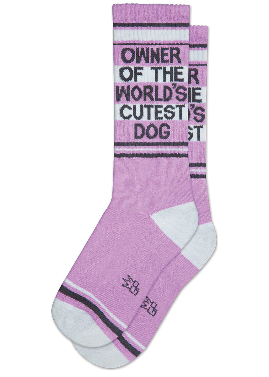 Funny purple crew-length dog socks that say “OWNER OF THE WORLD&#39;S CUTEST DOG” on the leg.