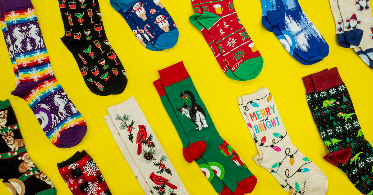 An array of Christmas socks with novelty designs displayed on a yellow background.