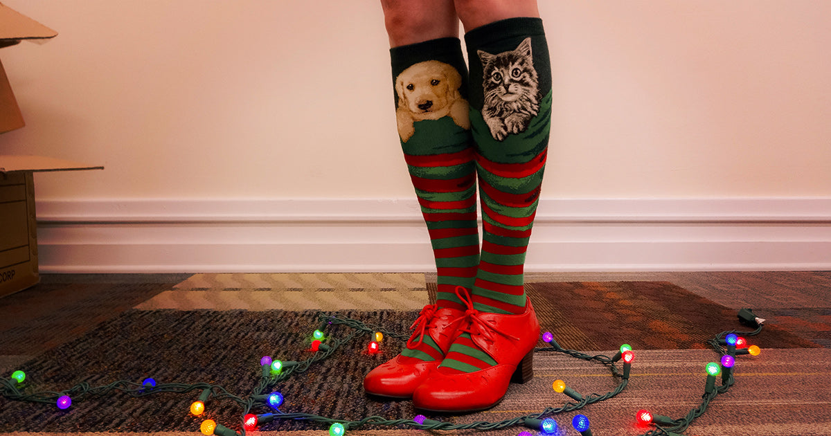 Knee-high Christmas socks that look like stockings with a puppy and a kitten inside.