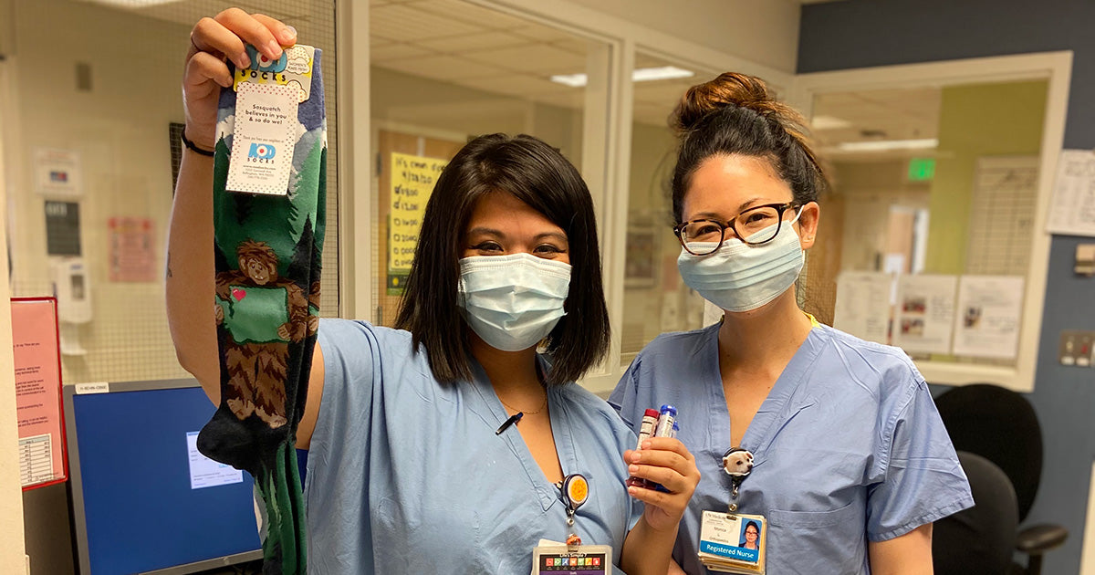 Harborview Medical Center staff hold up donated socks from ModSocks.