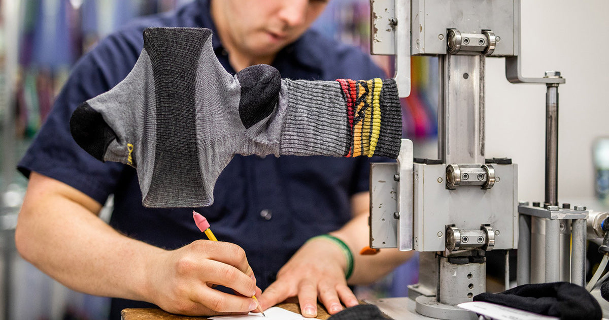 A worker tests the stretch of socks made in America