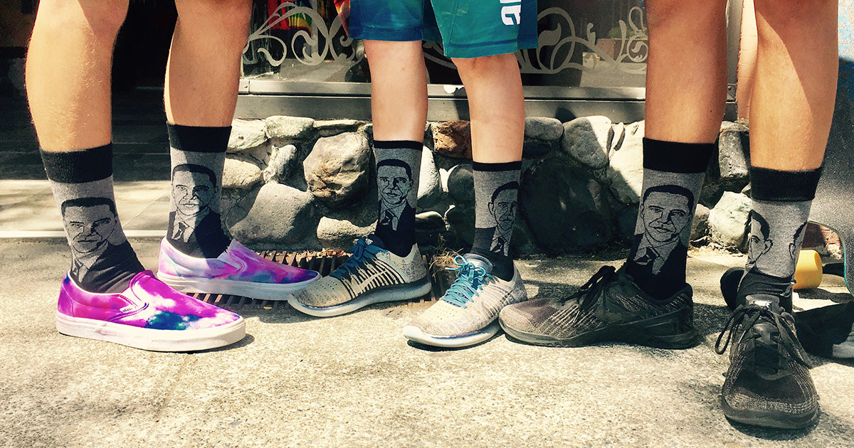 A trio of kids wear matching Obama socks with skateboarding shoes.