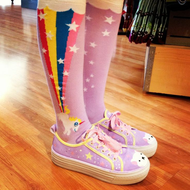 The farticorn (a farting unicorn), is one of many popular knee high socks among all ages in our Sock It To Me collection. This lilac knee high shows off poofy white clouds at the cuff, with a rainbow and stars appearing from a cute white prancing unicorn