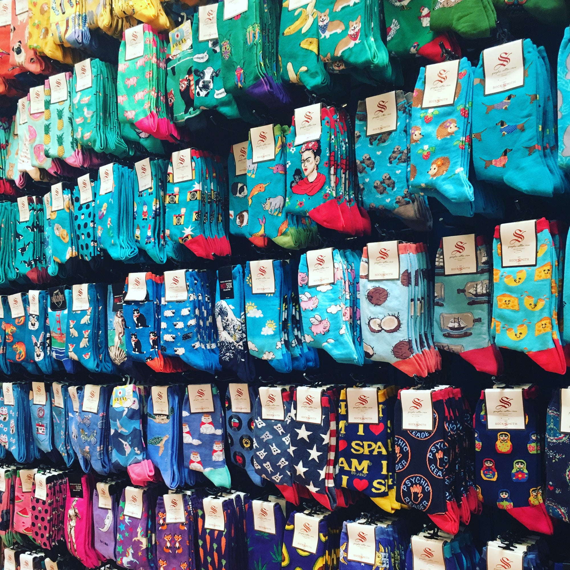 Women's novelty crew socks in a rainbow of colors featuring animals, art & food themes.