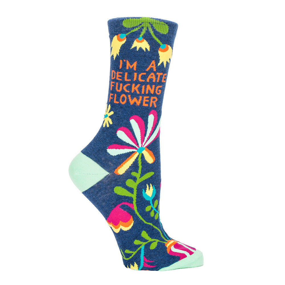 Swear word socks from Blue Q, like these blue crew socks that say "I'm a delicate fucking flower,” really take your crazy sock game straight to the gutter in the best way possible. 