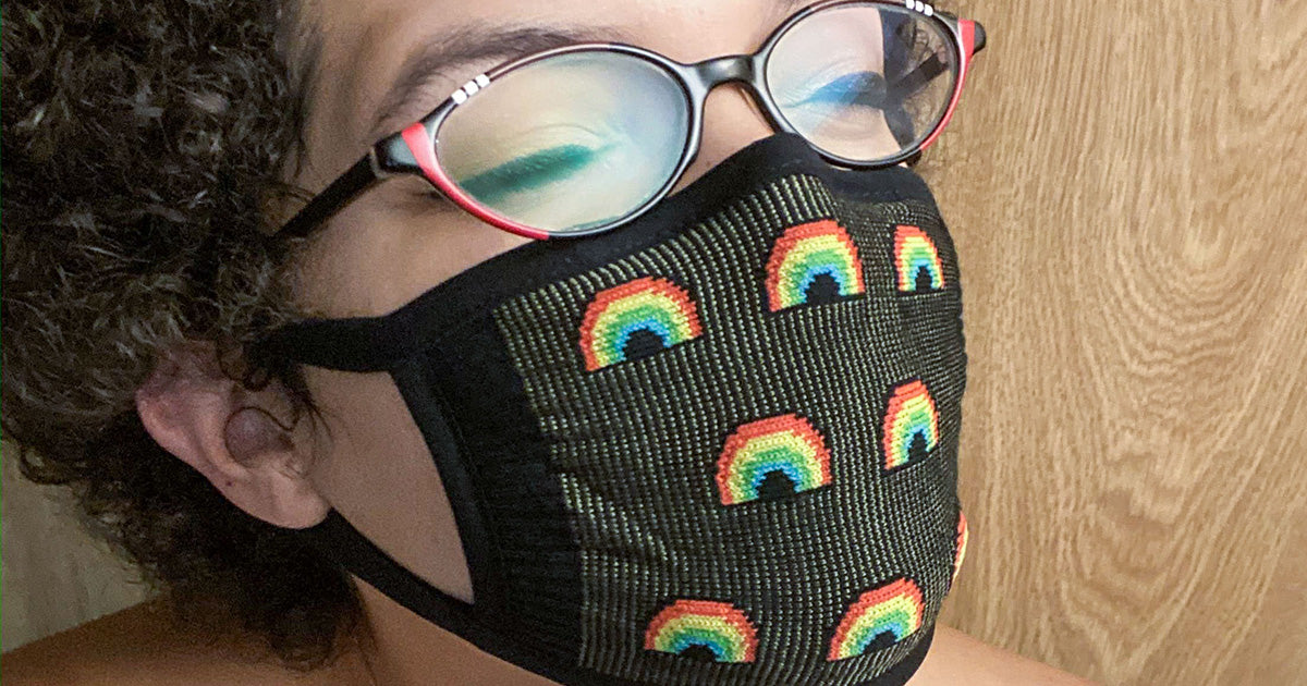 A rainbow-patterned reusable face mask for protection from COVID-19.