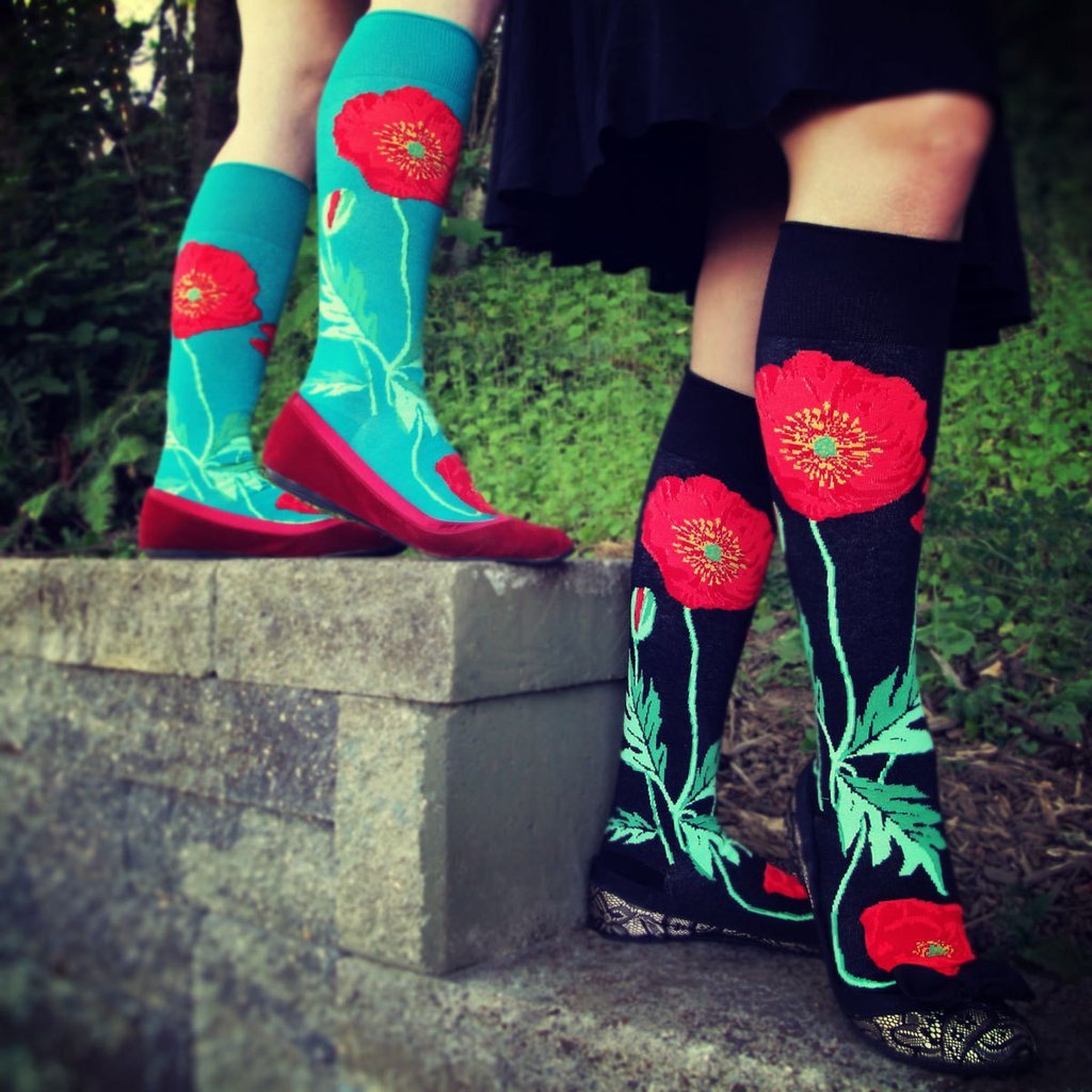 Red poppy flowers grow up these floral knee-high socks by ModSocks.