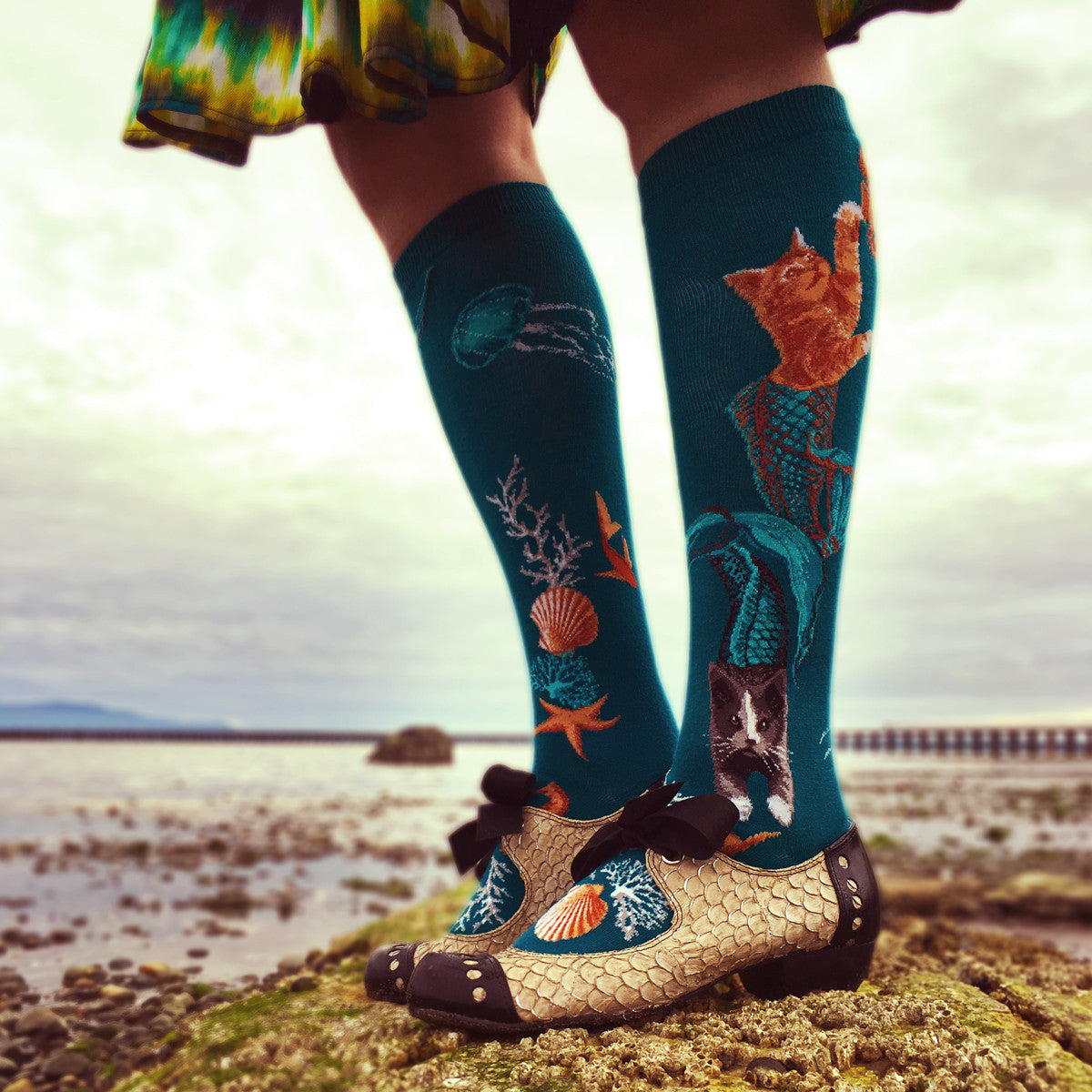 Purrmaids are part mermaid, part cat and 100% adorable as shown on ModSocks' ocean-themed deep teal knee socks, worn here with fish-scale spectator pumps.